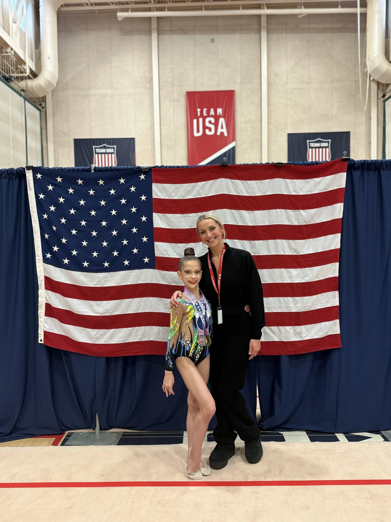 Gymnast posing in front of a United States flag